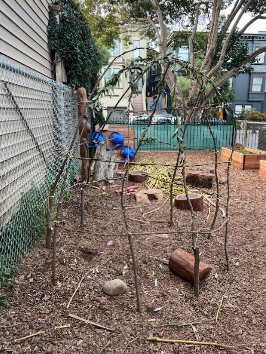 The wooden frame of the tule house taking shape in the school garden
